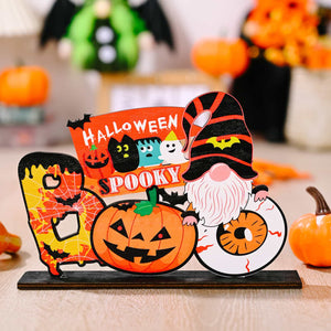 Halloween tabletop decor with spooky gnome, pumpkin, ghost, black cats, and eyeball.