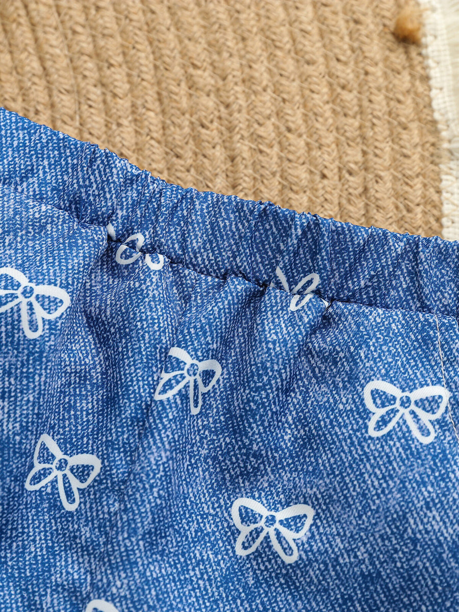 Blue cotton cami and shorts set with white bow print and elastic waistband.
