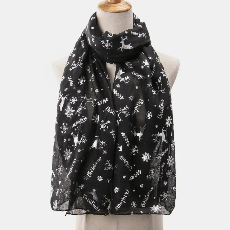 Black Christmas print metallic scarf with reindeer and snowflakes, on a mannequin.