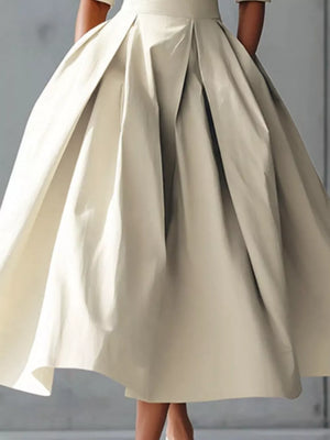Chic A-line midi dress in camel with a voluminous pleated skirt.