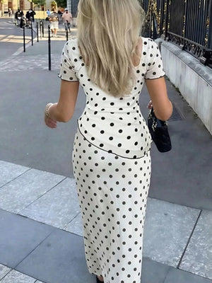 Ivory and black polka dot square neck top and midi skirt set with ruffled trim.