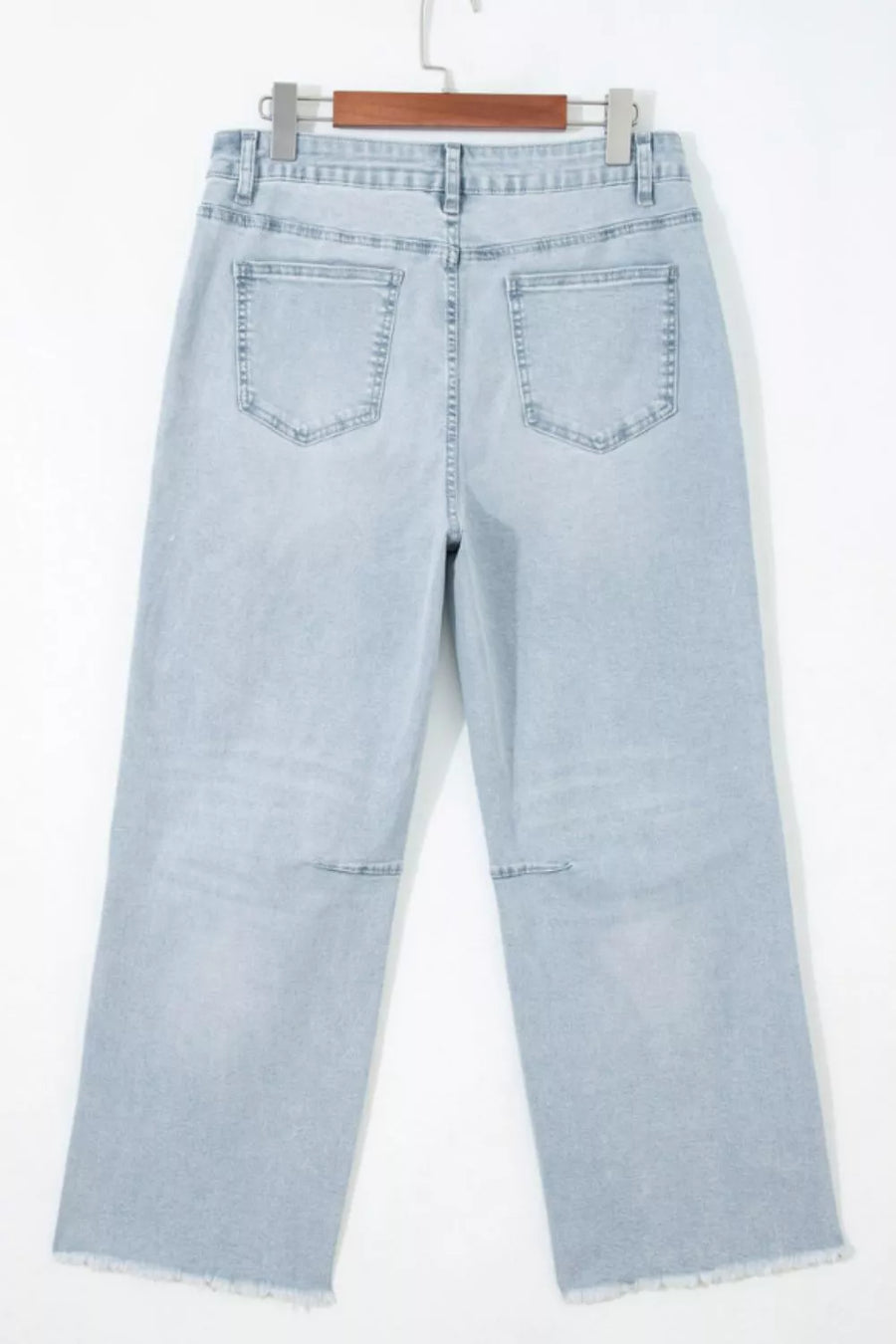 Light wash denim cropped utility jeans with frayed hem and knee detail