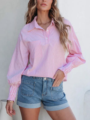 Pink striped button-up shirt with smocked cuffs, paired with cuffed denim shorts.