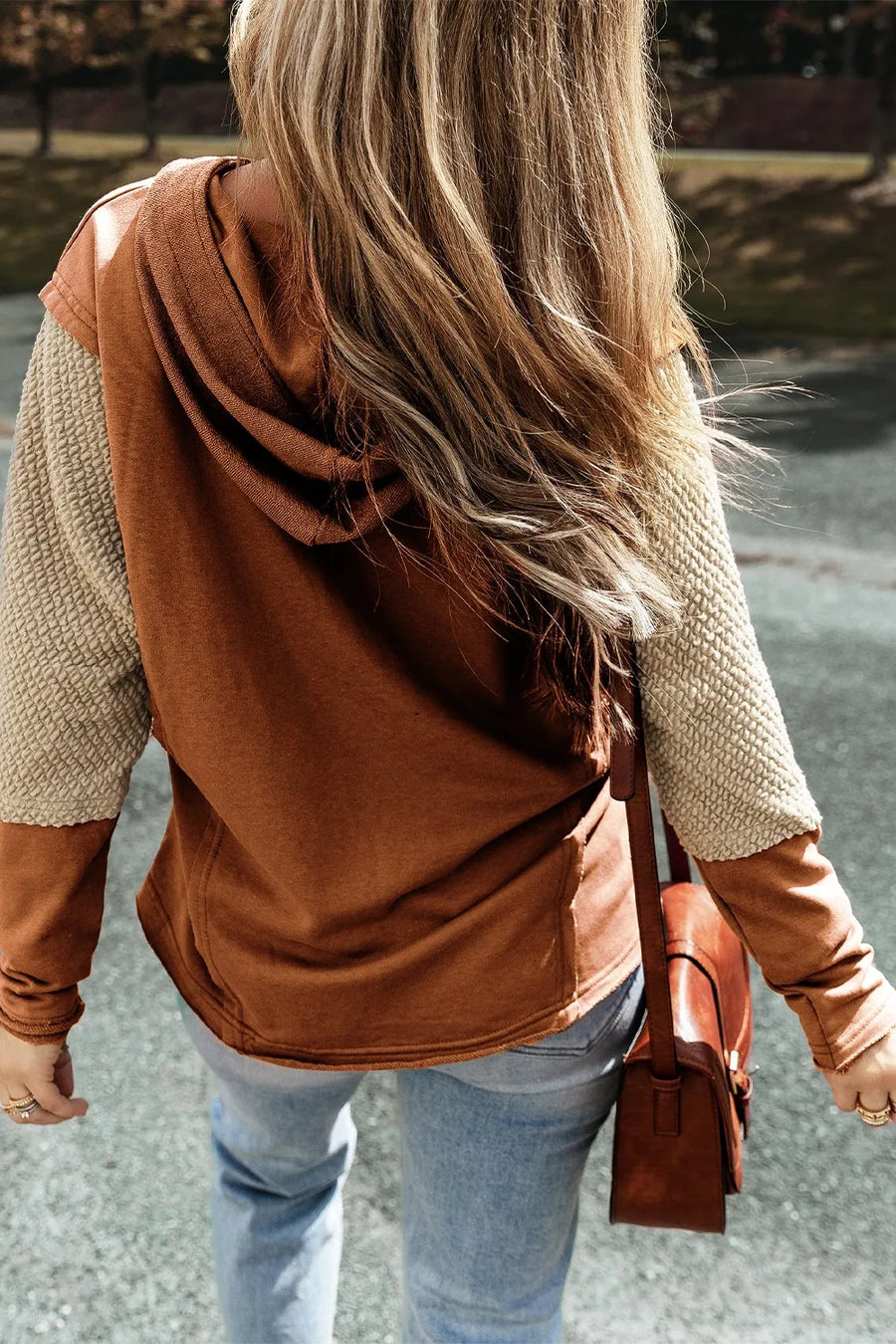 Caramel hoodie with textured sleeves and a drawstring hood.