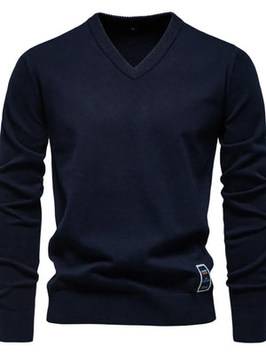 Navy ribbed knit V-neck sweater with a small logo tag on the hem.