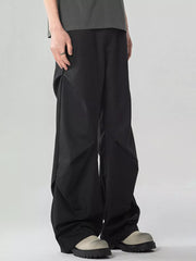 Black oversized wide-leg cargo sweatpants with a relaxed fit and unique paneling detail.