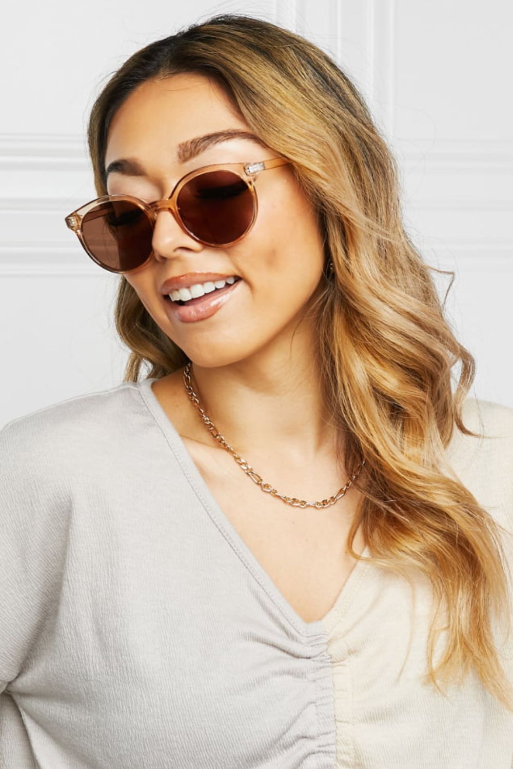 Tortoiseshell round frame sunglasses with brown lenses and tan frames.