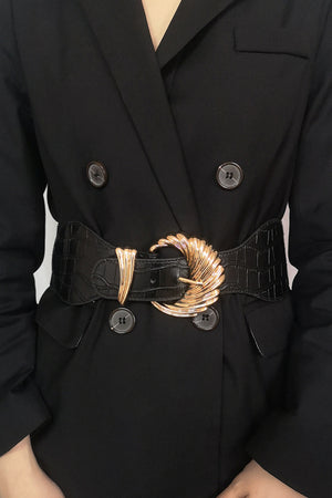 Black croc-embossed elastic belt with a sculptural gold buckle.