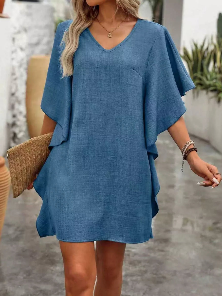 Blue V-neck mini dress with flowy sleeves and a textured fabric.