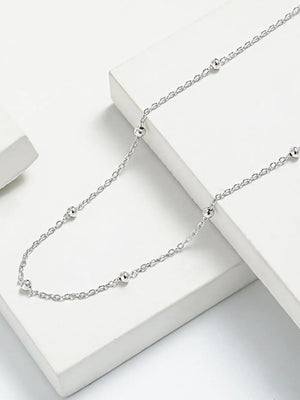 Delicate silver orb chain necklace with small, evenly spaced beads.