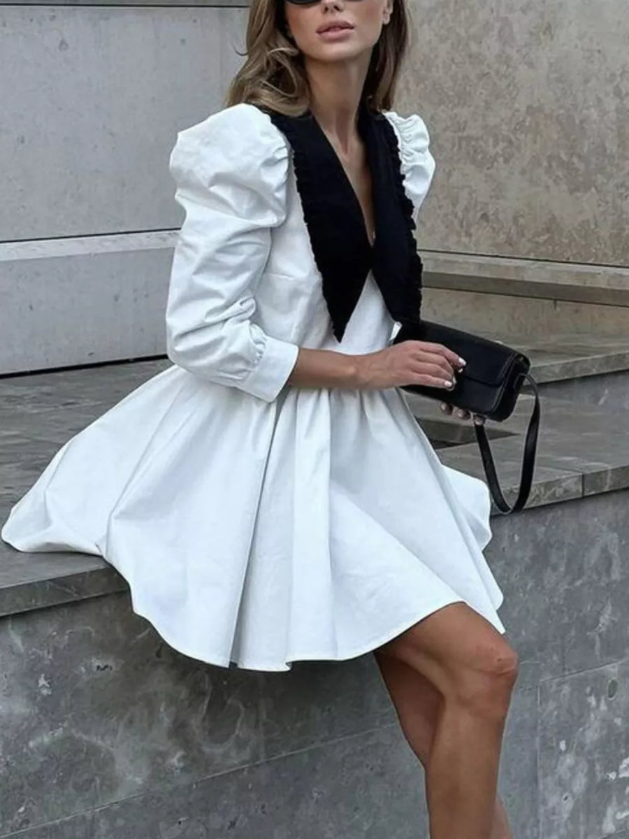 White puff sleeve mini dress with black ruffled collar and plunging neckline
