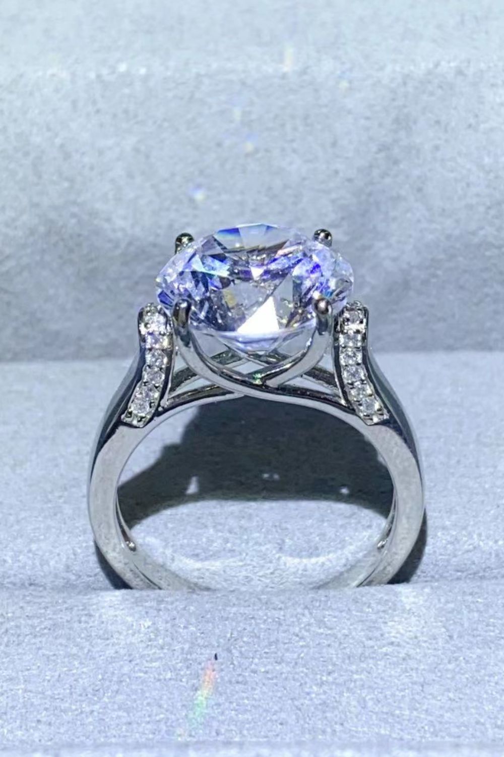 Silver ring with large radiant moissanite solitaire and pavé diamond shoulders