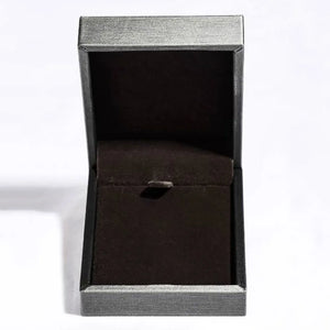 Open jewelry box with dark interior and textured silver exterior