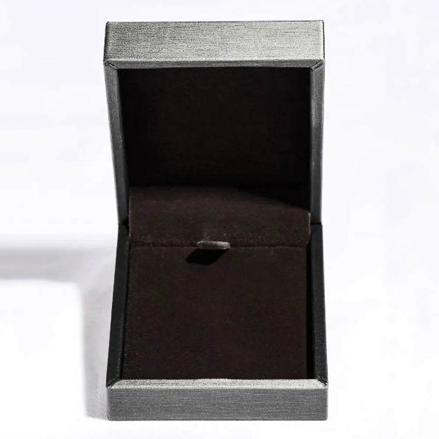 Open jewelry box with dark interior and textured silver exterior