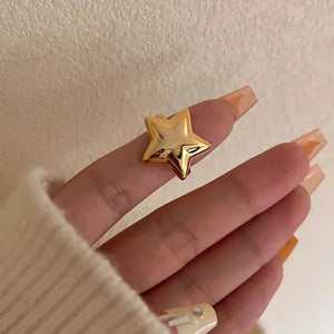 Gold starburst adjustable ring with a bold, sculpted design.