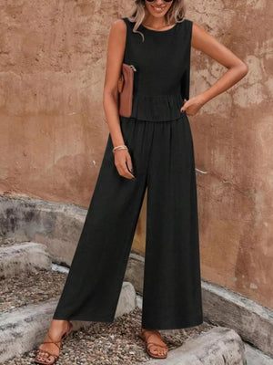 Black ruffled peplum top and wide-leg pants set with round neckline and sleeveless design.