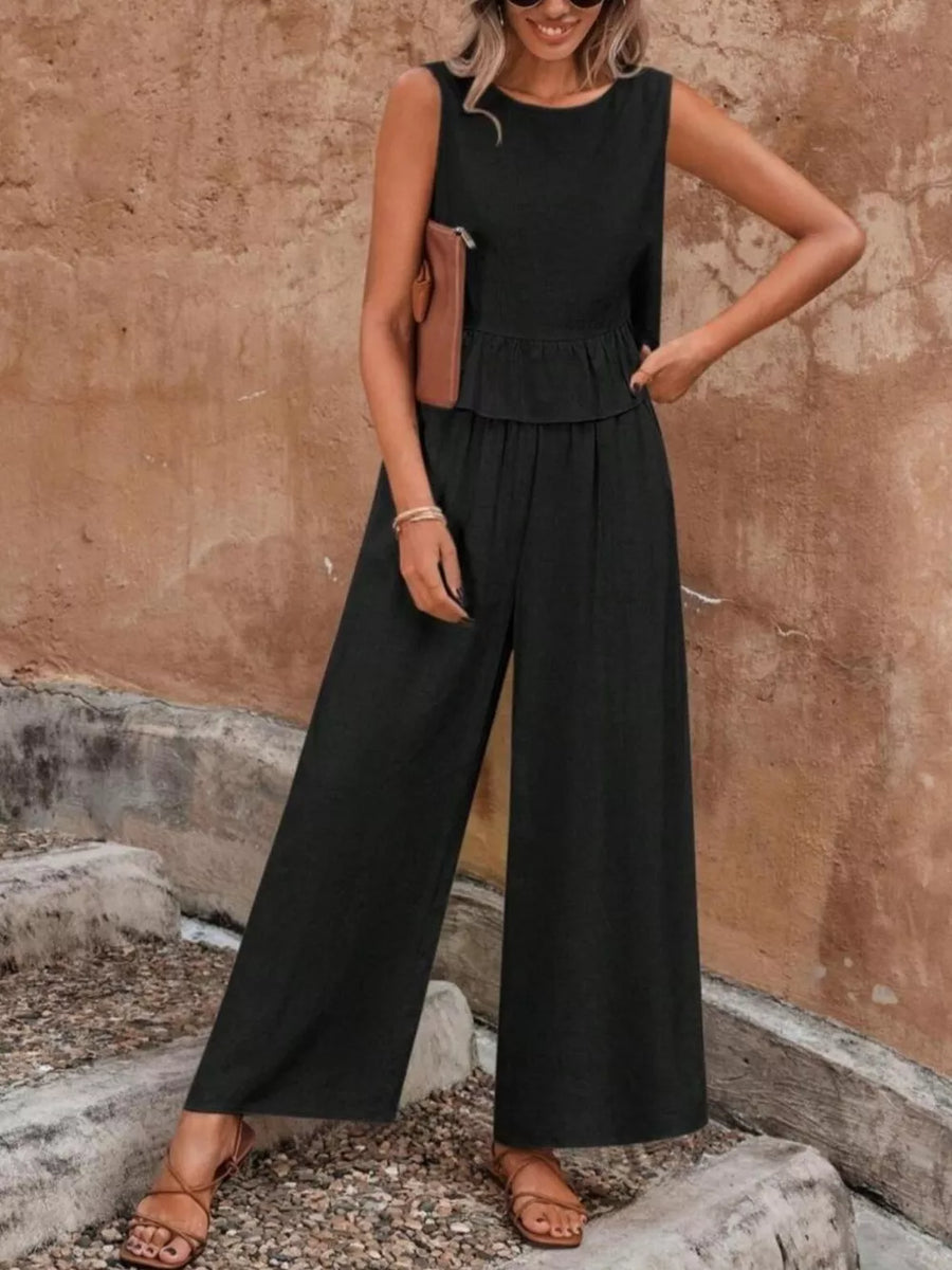 Black ruffled peplum top and wide-leg pants set with round neckline and sleeveless design.