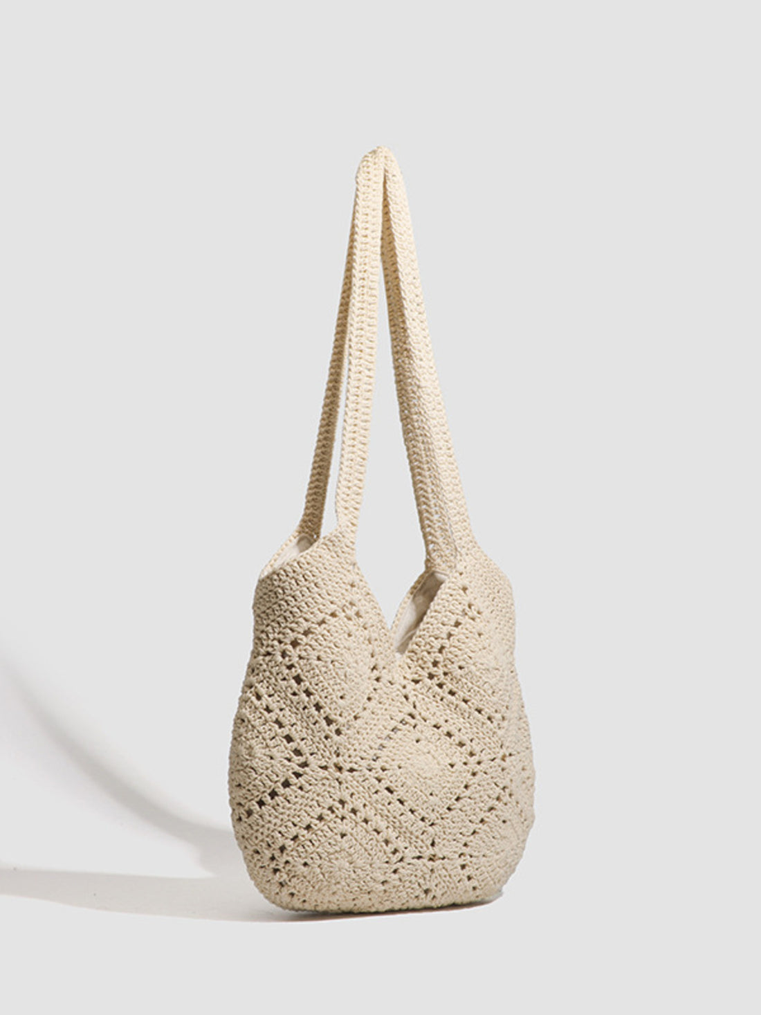 cream handbag featuring crochet knit and geometric