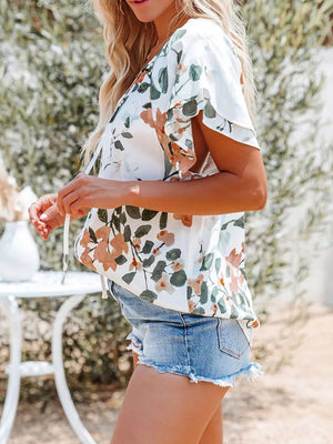 White floral print v-neck blouse with tie detail and flutter sleeves