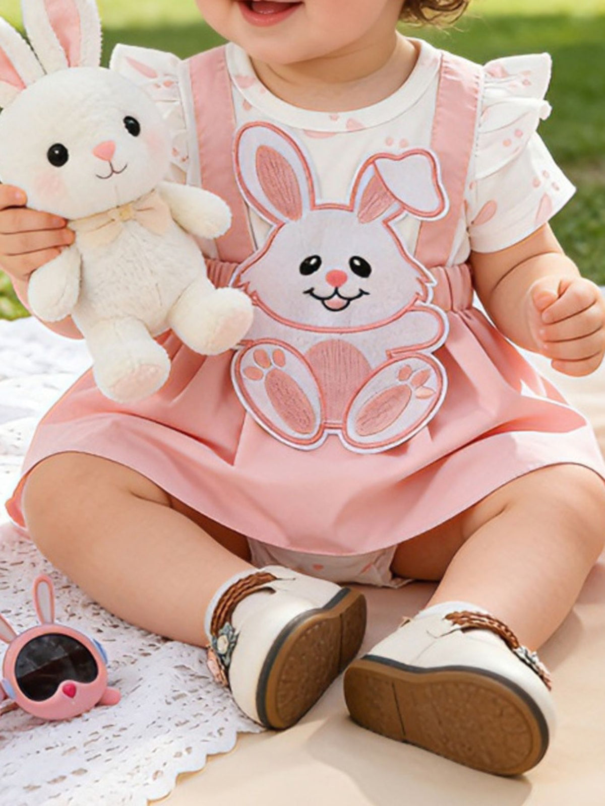 Pink baby dress set with bunny applique, ruffled sleeves, and bow detail.
