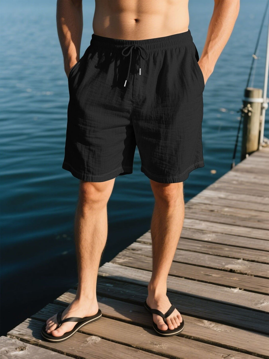 Black linen drawstring shorts with side pockets and a relaxed fit.