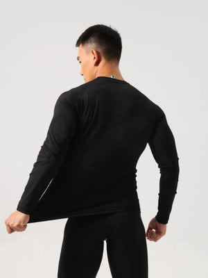 Black performance raglan sleeve tee showing stretch fabric and logo detail on back neck.