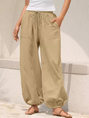 Khaki relaxed harem pants with drawstring and contrast stitching detail.