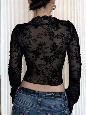 Black sheer t-shirt with intricate floral burnout pattern and lace trim neckline.