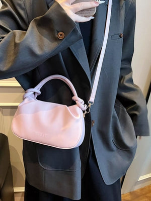 Pink ruched crossbody bag with knotted handle and long strap