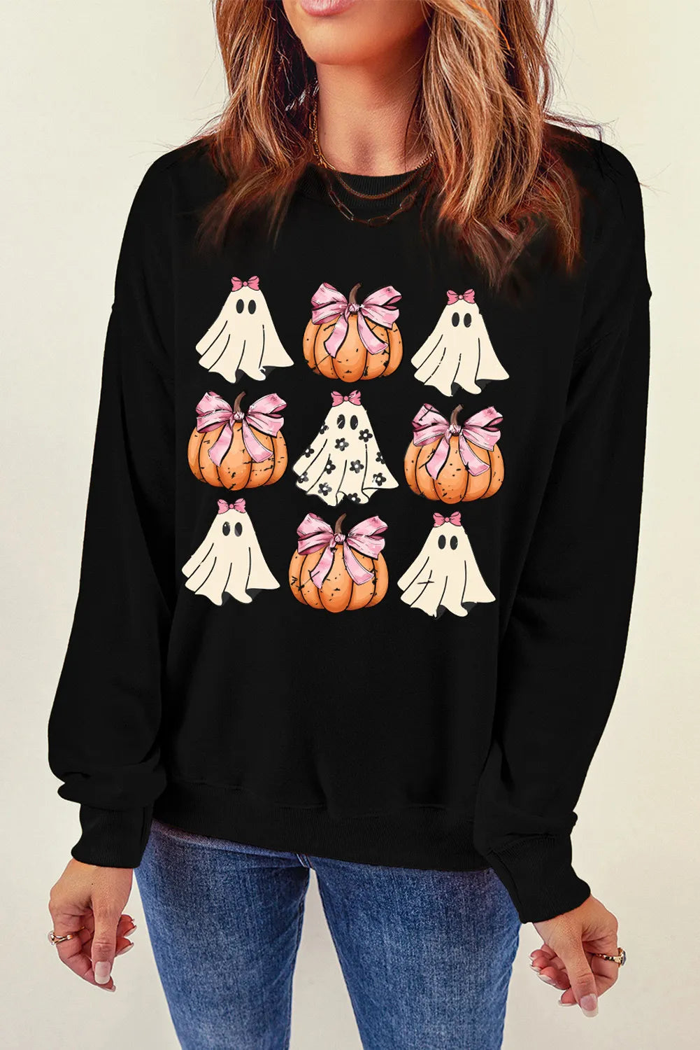 Black crewneck sweatshirt with a Halloween graphic of pumpkins and ghosts.