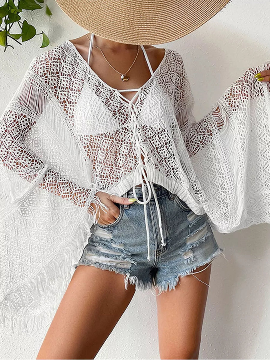 White crochet knit beach cover-up with fringe and lace-up neckline.