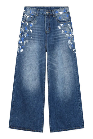 Painterly Wash Wide Leg Jeans in medium blue denim with artistic brushstroke details and a relaxed fit.
