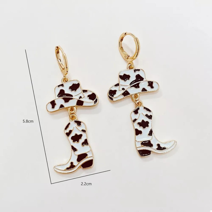 earrings in black with cow print and dangle