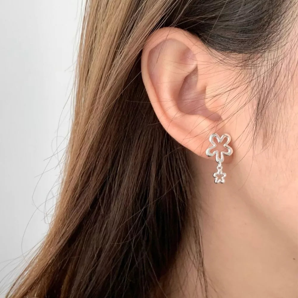 Silver earrings featuring drop design and floral