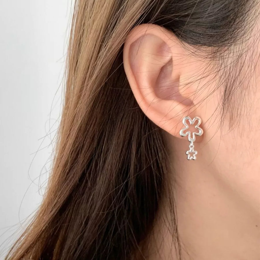 Silver earrings featuring drop design and floral