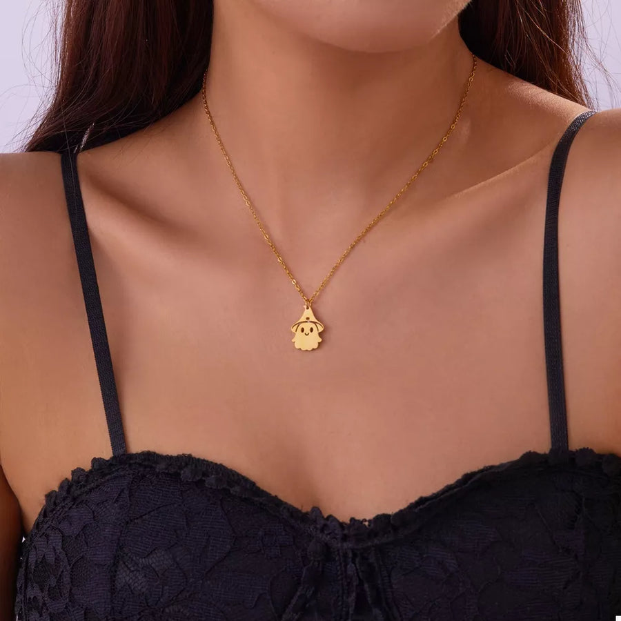 Gold necklace featuring pendant and figural