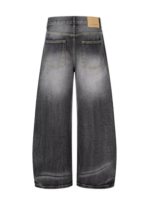 Men's black distressed wide-leg cotton jeans with a faded wash and relaxed fit.