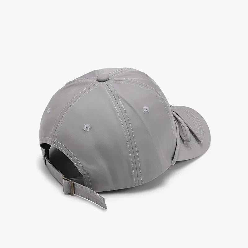 Gray baseball cap with adjustable strap and tied-back detail