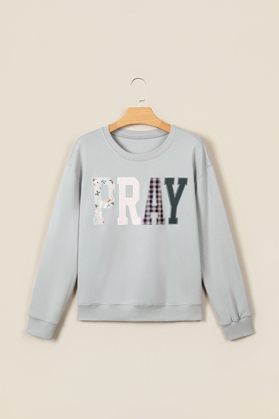pullover sweater in light pink with patchwork and chenille patch