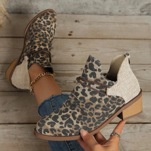 Leopard print cutout ankle boots with braided detail and side panels.