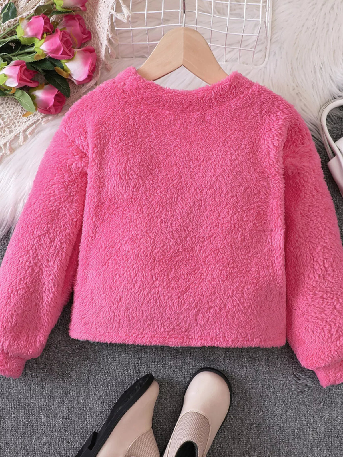 Fuzzy hot pink sweatshirt for kids with long sleeves and a crew neck.