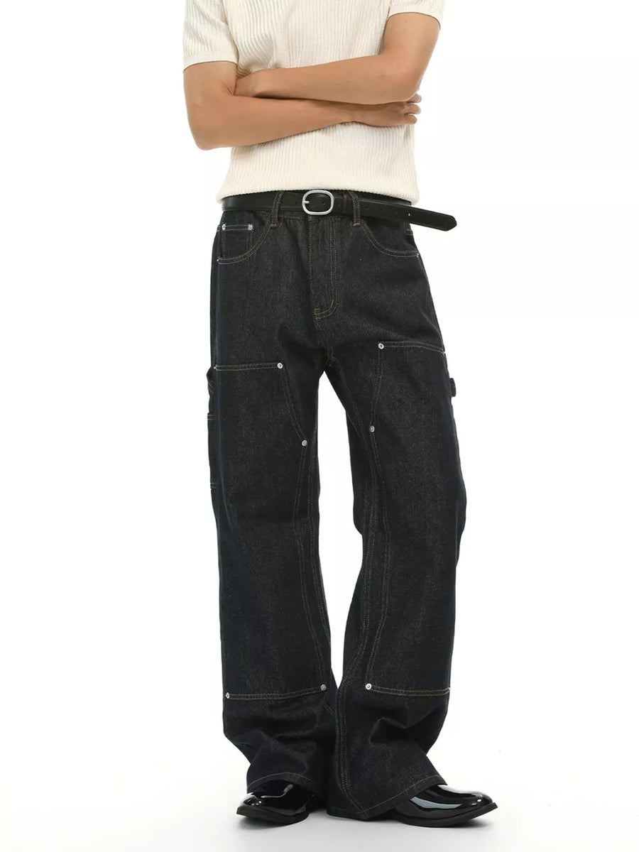Dark wash cotton blend carpenter jeans with distinctive pockets and contrast stitching.