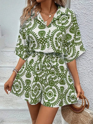 Green printed tie-waist romper with button-up collared shirt and short sleeves.