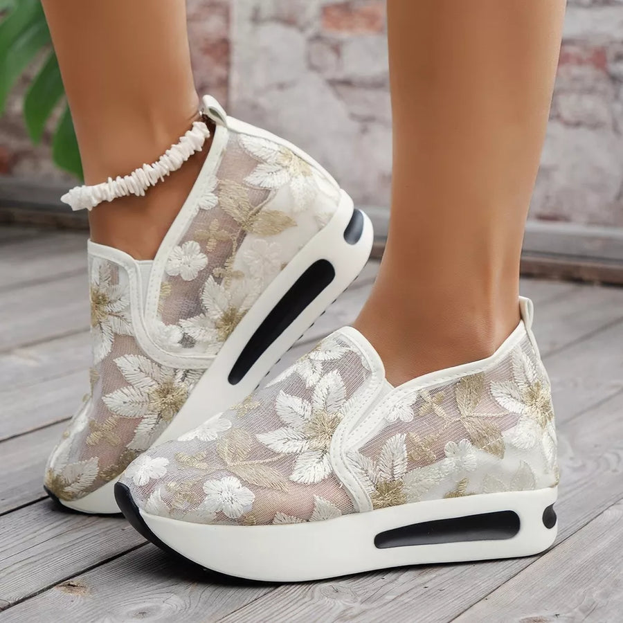 White floral embroidered mesh slip-on sneakers with a chunky platform sole.
