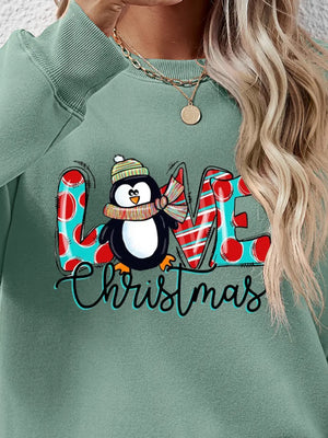 Sage green sweatshirt with festive penguin graphic and "Christmas" text.