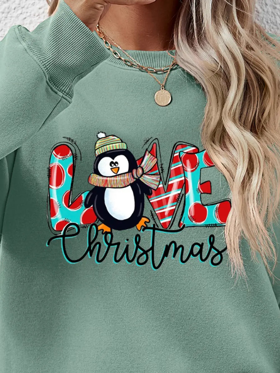Sage green sweatshirt with festive penguin graphic and "Christmas" text.