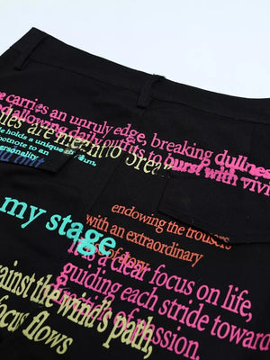 Black cargo pants with colorful text print and cargo pockets.