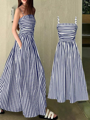 Navy blue and white striped maxi dress with spaghetti straps, cinched waist, and pockets.