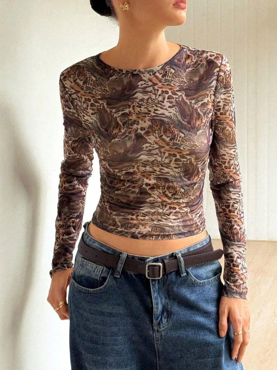 Sheer leopard print long-sleeve top in brown with a round neckline.