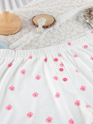 White ribbed knit pajama pants with pink floral print and button detail